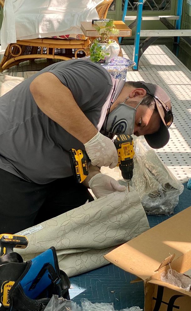 Man installing shades