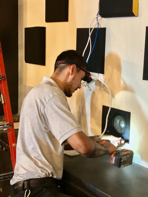 Man installing speaker 